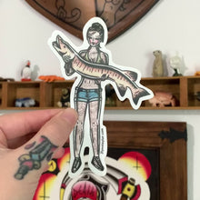 Load and play video in Gallery viewer, American traditional tattoo flash illustration Muskie Fishing Pinup watercolor sticker.
