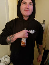 Load image into Gallery viewer, Man wearing tattoo style butt heart logo on a black hoodie.
