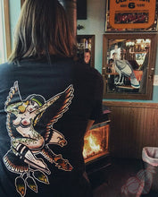 Load image into Gallery viewer, Female in front of wood burning stove wearing a tattoo style eagle and pinup shirt.
