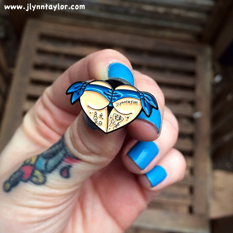 American traditional tattoo flash blue scrunch butt bikini butt heart enamel pin.