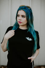 Load image into Gallery viewer, female model with teal hair wearing tattoo style butt heart logo shirt.
