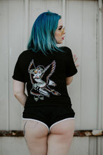 Load image into Gallery viewer, Female model in short shorts wearing a tattoo style eagle and pinup shirt.
