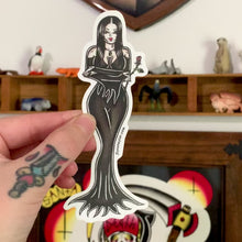 Load and play video in Gallery viewer, American Traditional tattoo flash illustration Morticia Addams Cara Mia pinup watercolor sticker.
