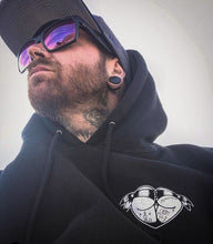 Load image into Gallery viewer, Man wearing a tattoo style butt heart logo hoodie.
